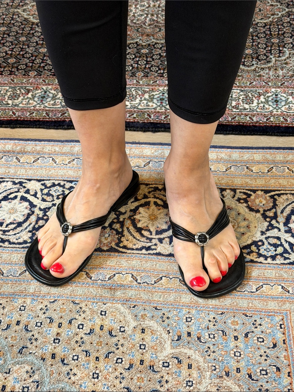 A Pair of Brighton Women’s Black Thong Sandals with Decorative Buckle in Size 7